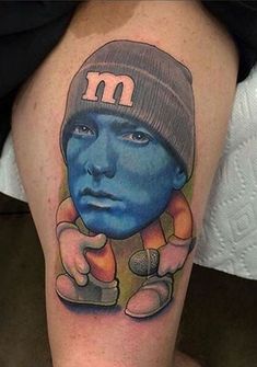 a man with a blue face and hat on his leg