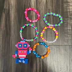 One Size Handmade Robot Perler Charm 5 Bracelets Total Beep Boop Trippy Fly Love Iheartraves For Exposure Message Me If You Have Any Questions Or Want A Custom Bracelet! Kandi Diy, Rave Kandi Bracelets, Perler Bead Bracelet, Handmade Robot, Rave Bracelets, String Friendship Bracelets, Fly Love, Team Bracelets, Kandi Inspo