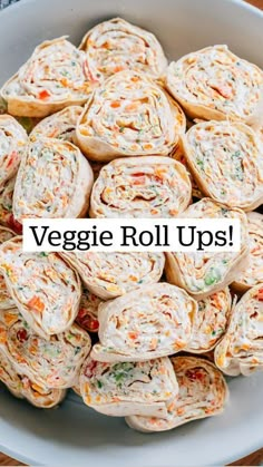 a white bowl filled with veggie roll ups