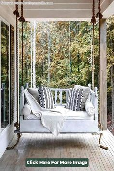 a white porch swing bed with pillows on it and the words click here for more images