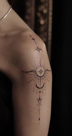 a woman's arm with a sun and moon tattoo on the left upper arm