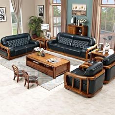 a living room filled with black leather furniture