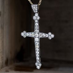 An antique cross studded with diamonds that are absolutely drool worthy. We love the classically Victorian details on the cross, giving the pendant a glamorous (and pretty bad ass!) look overall. The old mine cut stones throughout the cross are a sight to be seen - incredibly playful and the slight variance in color adds to the pendant’s innate charm. Plus - who can resist a diamond encrusted bale?Silver on 18kt Yellow Gold, 3.1" in height.Diamonds are estimated to be I/J to O/P colors & hav Luxury Elegant Crucifix Cross Necklace, Luxury Ornate Cross Pendant Necklace, Victorian Details, Modern Mens Rings, Art Jewelry Earrings, Bespoke Rings, Antique Watches, Diamond Cross Pendants, Antique Engagement