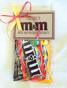 a candy bar wrapped in cellophane and tied with a ribbon