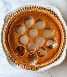 a pumpkin pie with several holes in it