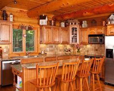 a large kitchen with wooden cabinets and an island in front of the stove top oven