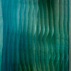 an abstract painting with wavy lines in green and blue