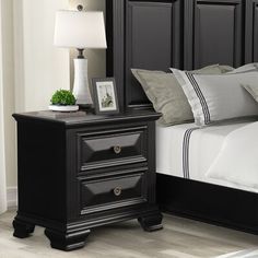 a bedroom with a bed, night stand and nightstand