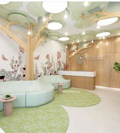 the interior of an office decorated in pastel colors and with green rugs on the floor