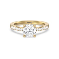 a diamond engagement ring with two rows of diamonds on the band and an 18k rose gold