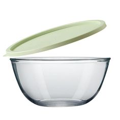 a glass bowl with a green lid and an empty plastic container in the bottom, on a white background