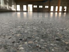 the floor in an empty building has many small rocks on it