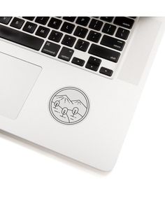 an open laptop computer sitting on top of a white table