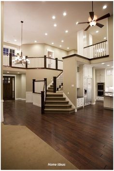 a large open floor plan with stairs leading up to the second story