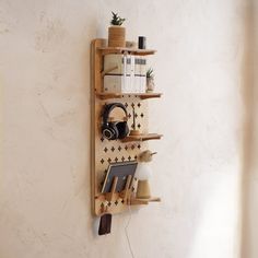 a wooden shelf with books and headphones hanging on it's side against a wall