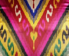 a multicolored fabric with an ornate design on the front and back side,