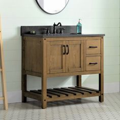 a bathroom vanity with a mirror above it and a ladder leaning against the wall next to it