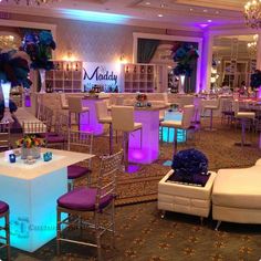 a banquet hall decorated with purple and white decor