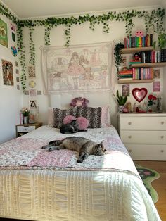 a cat laying on top of a bed in a bedroom