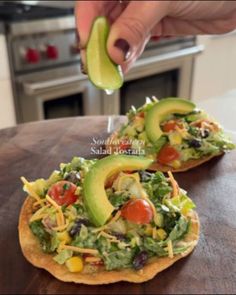 an avocado is being drizzled on top of a tortilla