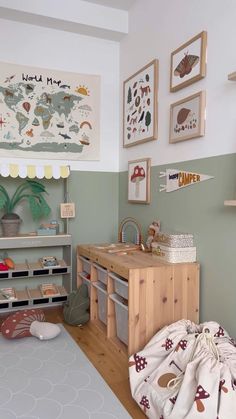 a child's bedroom with green walls and pictures on the wall