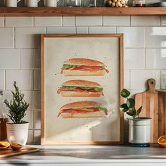 three sandwiches are displayed in front of a white tiled wall and wooden shelf with potted plants