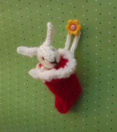 a small stuffed animal hanging from the side of a christmas stocking ornament