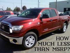 a red pickup truck parked in a parking lot