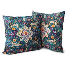 two pillows with colorful floral designs on the front and back, one is blue and the other is green