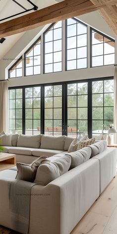 a living room with large couches and windows in the ceiling, along with wooden flooring