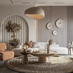 a living room with white couches, chairs and round coffee table in the center