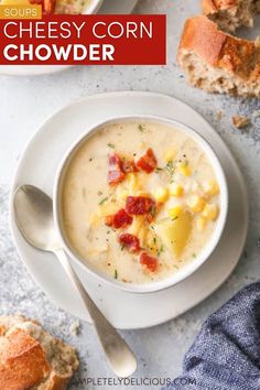 a bowl of cheesy corn chowder with bread on the side