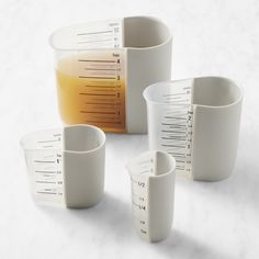 measuring cups and beakles on a white surface