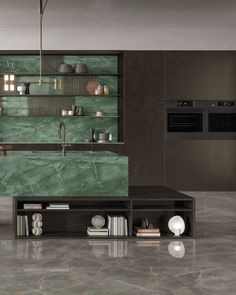 a modern kitchen with green marble counter tops