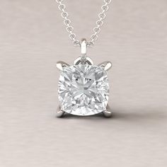 "This handmade pendant begins with a flawless, Charles & Colvard Forever One DEF Moissanite gemstone. This square cushion-cut beauty measures 9mm and averages 3.30 carats DEW. It is set with prongs that are polished into fang or claw prongs. The pendant features a side halo of genuine diamonds. There are 20 natural, high quality white diamonds averaging 0.10 ctw. All diamonds average F-G, VS2-SI1. The chain of your choice can be purchased separately. BUY THE CHAIN HERE: https://www.etsy.com/ Square Pendant Diamond Necklace With Prong Setting, Square Pendant Diamond Jewelry With Vvs Clarity, Vvs Clarity Solitaire Pendant Necklace With Lab-grown Diamond, Elegant Solitaire Necklace With Square Pendant And Single-cut Diamonds, Vvs Clarity Square Diamond Pendant, Cushion Moissanite Engagement Ring, Cushion Solitaire, Halo Band, Moissanite Pendant