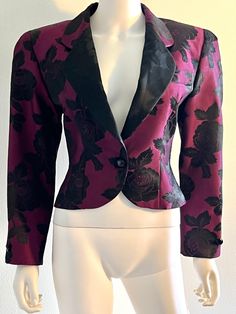 "Vintage blassport by Bill Blass purple and black short jacket or bolero jacket, featuring a single button front closure, an all over floral motif, and gorgeous jacquard detailing.  Fully lined.  Shoulder pads. Approximate Measurements:      Bust:  36\"; Waist: 30\"; Length: 20 1/2\"      No size label - likely a size Small based on measurements. Fabric:  No fabric label; feels and looks like silk or a silk blend. Condition: Very good to excellent vintage condition." Vintage Purple Formal Outerwear, Purple Long Sleeve Evening Blazer, Vintage Long Sleeve Purple Blazer, Vintage Purple Long Sleeve Blazer, Fitted Vintage Purple Blazer, Fitted Purple Evening Outerwear, Formal Jacket, Bolero Dress, White Plains