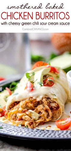 shredded chicken burritos with cheesy green chili cream sauce on a plate