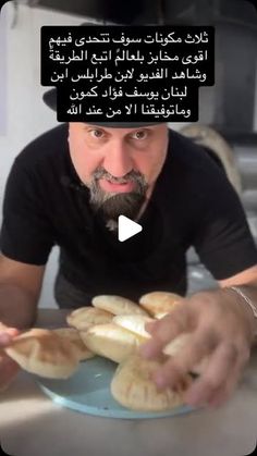 a man sitting at a table with bread in front of him and an ad on the screen