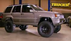 a silver truck parked inside of a garage