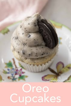 an oreo cupcake with cream frosting and chocolate cookies on top is shown