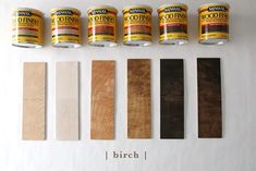 five cans of wood paint next to each other on a white surface with text below