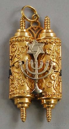 an ornately decorated gold and silver keychain with a jewish symbol on it