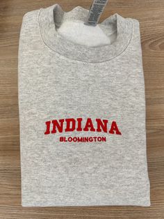 If you want a custom order or have any questions, please message me! -Bloomington Indiana embroidered crewneck -50/50 cotton/polyester -Unisex sizing: fits true to size. Order one size up for a looser fit. Custom Embroidered Crew T-shirt For College, Custom Embroidery Crew T-shirt For College, College Crew T-shirt With Custom Embroidery, College Crew T-shirt With Embroidered Text, Custom Embroidery Crew Neck T-shirt For College, School Spirit Crew Neck T-shirt With Embroidered Text, Bloomington Indiana, College Kids, Embroidered Crewneck