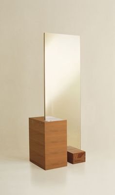 a mirror sitting on top of a wooden stand next to a box with a tissue dispenser