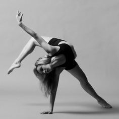 a woman doing a handstand on one leg