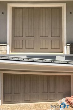 two garage doors are open in front of a house