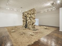 an art installation in a large room with wood flooring