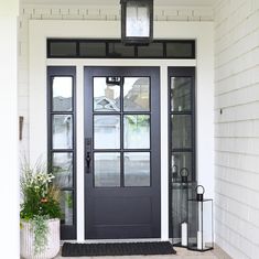 a black front door on a white house