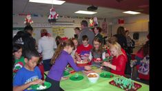 a group of people standing around a green table