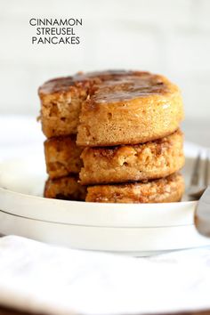 stack of cinnamon streusel pancakes on a white plate with a fork next to it